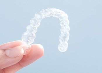 Patient holding clear aligner