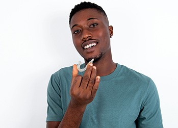 Naperville patient placing Invisalign tray 