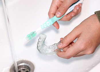 Invisalign tray being gently cleaned in Naperville 
