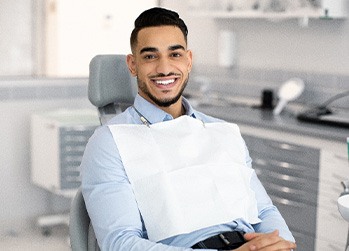 Man smiling while sitting in treatment chair