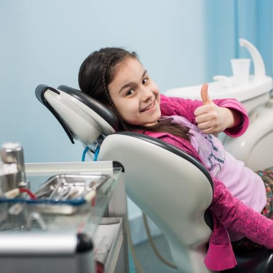 child giving thumbs up during emergency kid's dentistry visit