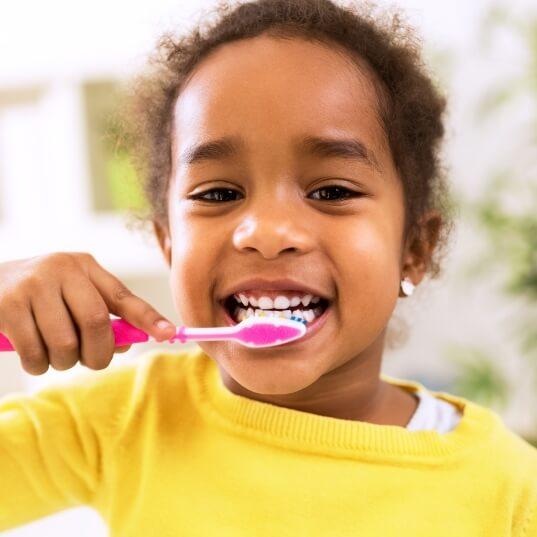 Child brushing teeth to prevent dental emergencies