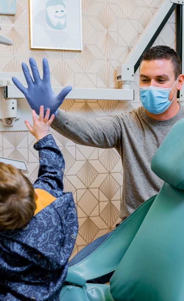 Pediatric dentist in Naperville Illinois giving child a high five