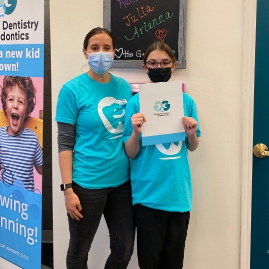 Orthodontist and patient smiling together