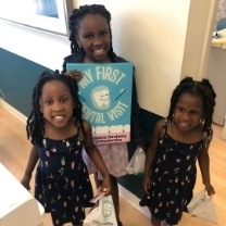 Young dental patient holding a cavity free smile sign