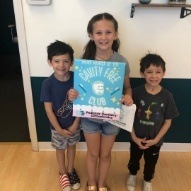 Three young dental patients smiling with cavity free club sign