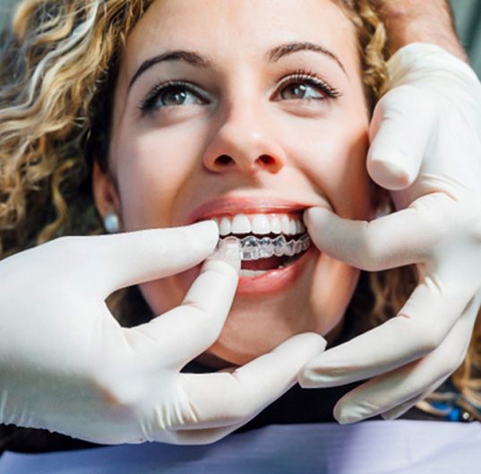 patient smiling while getting Invisalign 