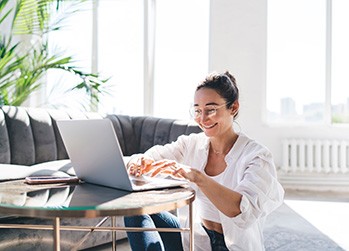 Woman smiling while working at home