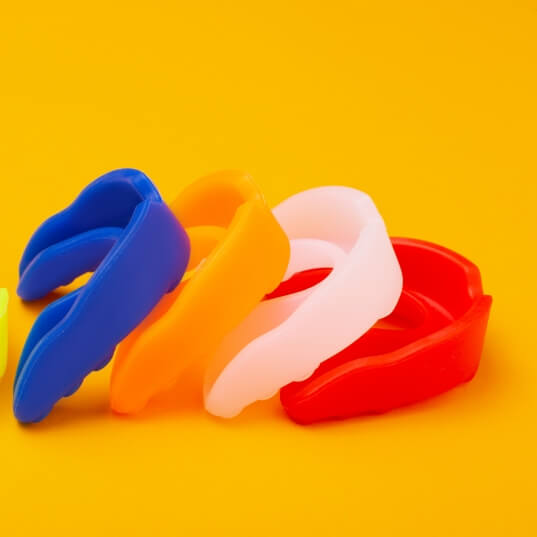 Row of mouthguards of various colors