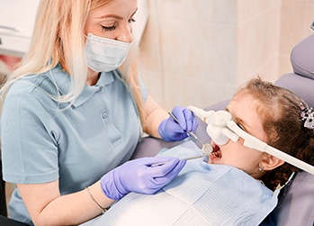 Little girl undergoing dental exam with nitrous oxide