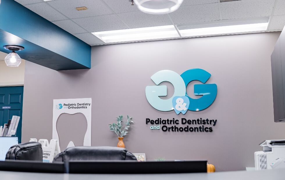 G and G Pediatric Dentistry and Orthodontics logo on dental office wall