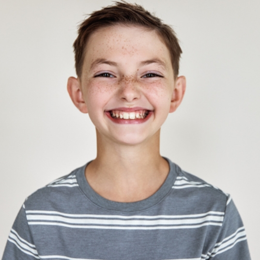 Smiling child with orthodontic appliance