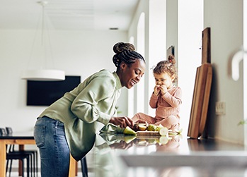 Mother and child eating healthy snack at home
