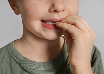 Closeup of child biting their nails