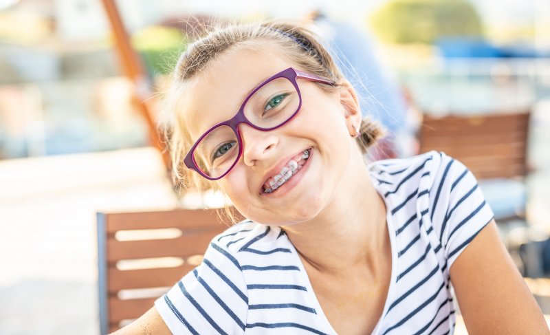 A smiling pre-teen girl wearing braces