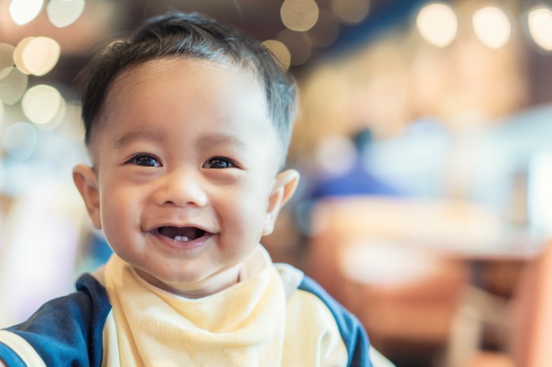 Smiling baby with a few baby teeth