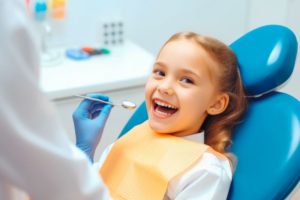 Happy little girl undergoing dental checkup