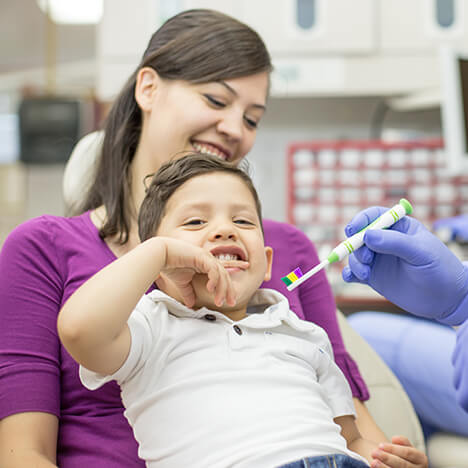parent helping child with special needs dentistry