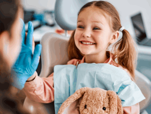 Child high fiving dentist