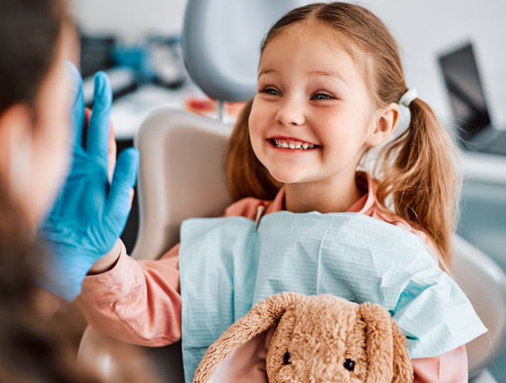 Child high fiving dentist
