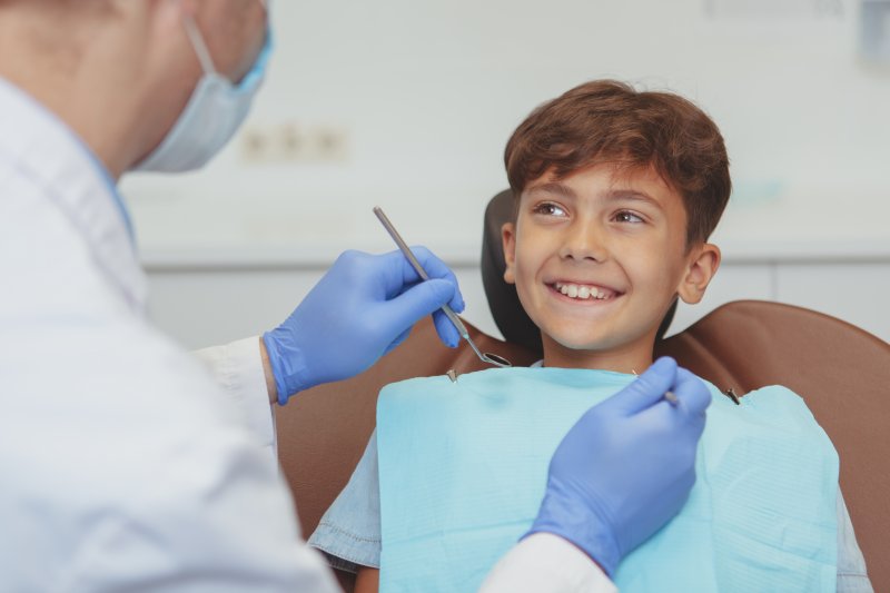 Kid smiles at dentist