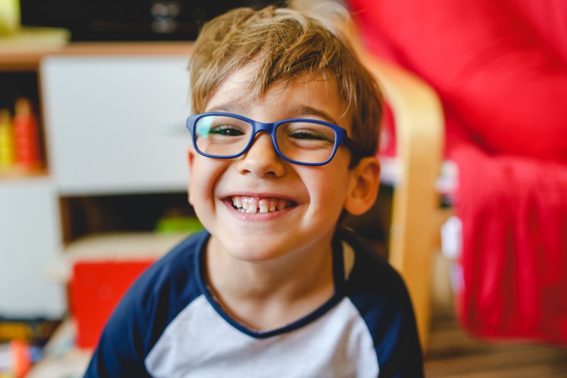 A smiling boy wearing eyeglasses