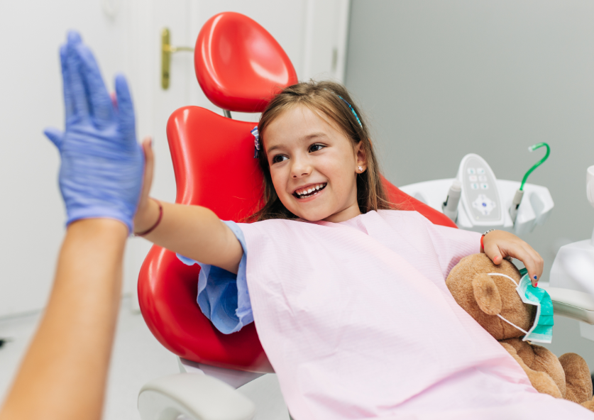 Little girl high fiving dentist