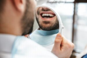 Man smiling into a mirror